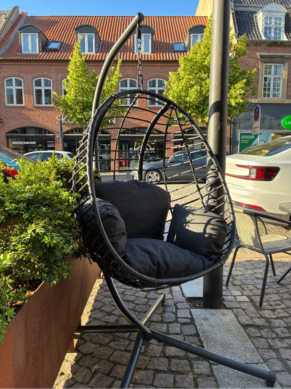 Hængestol på fortovet foran caféen